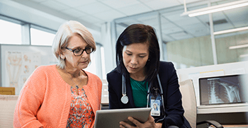 doctor and patient looking at tablet