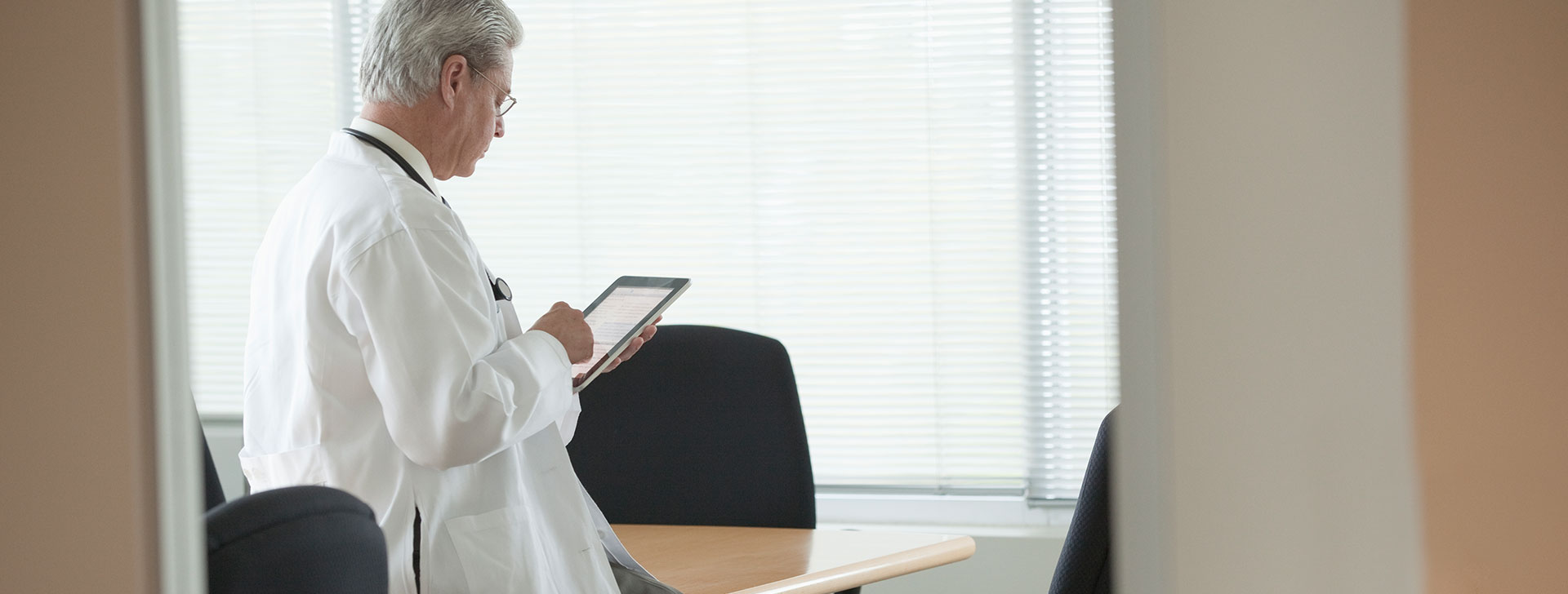 Doctor looking at tablet