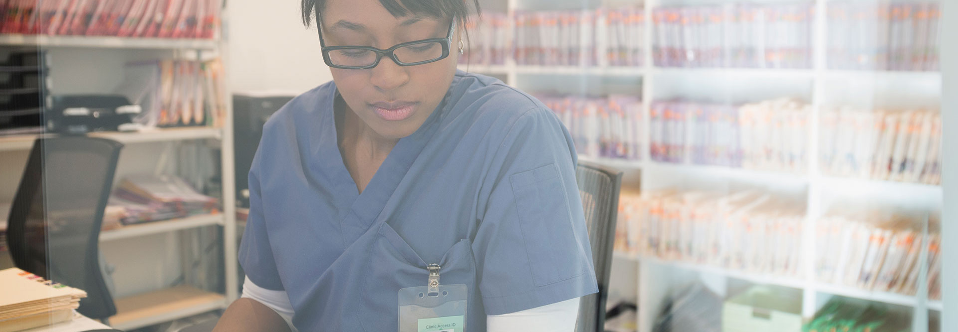 Nurse entering patient information into computer